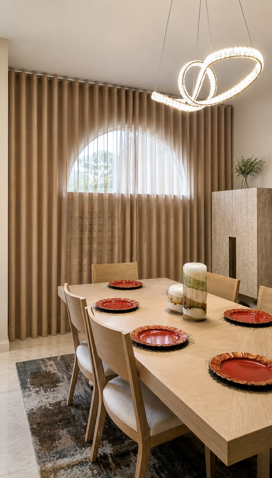 Beige drapery with a sheer center panel on an arched dining-room window