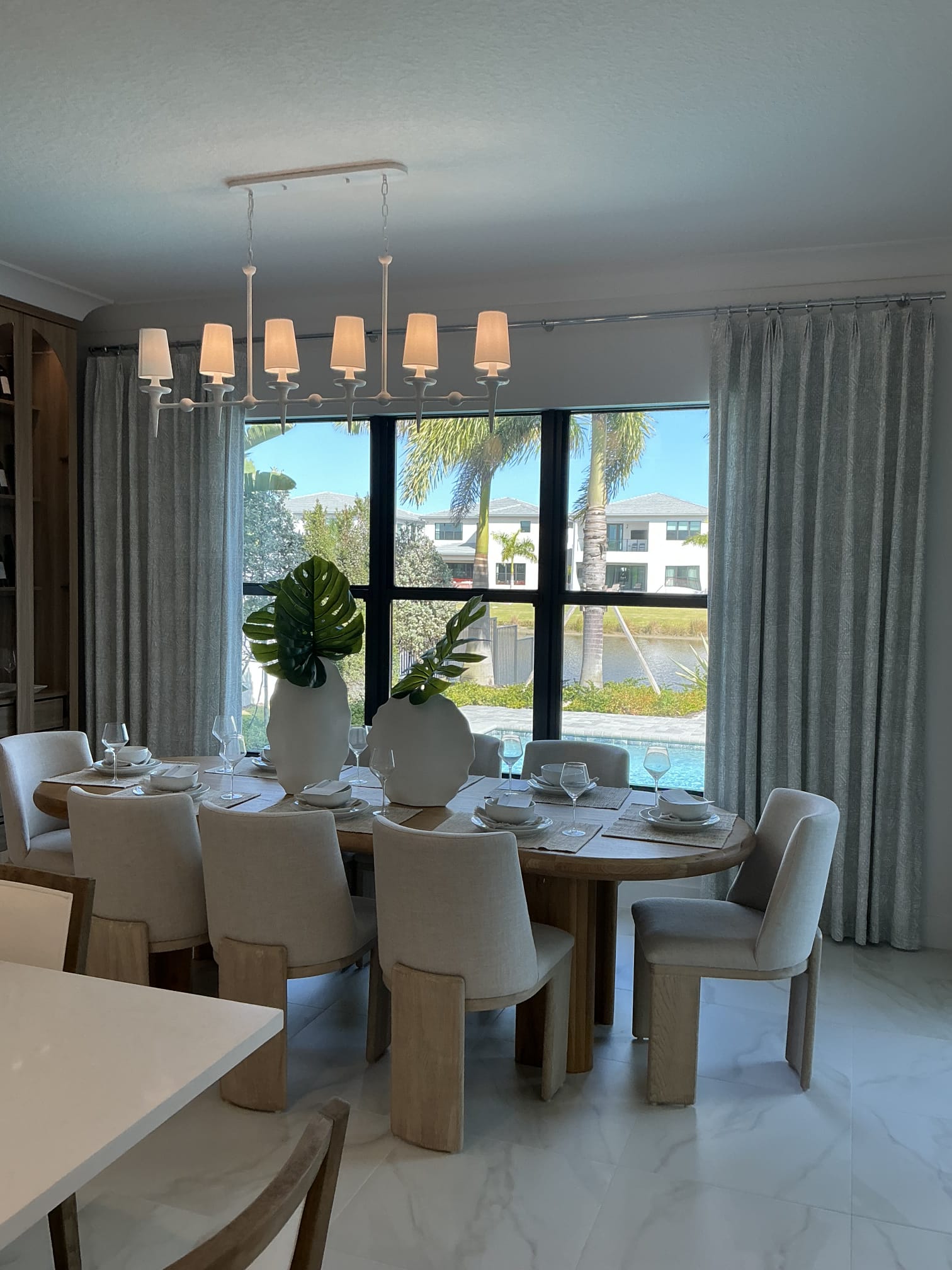 Grey drapery flanking a wide dining window