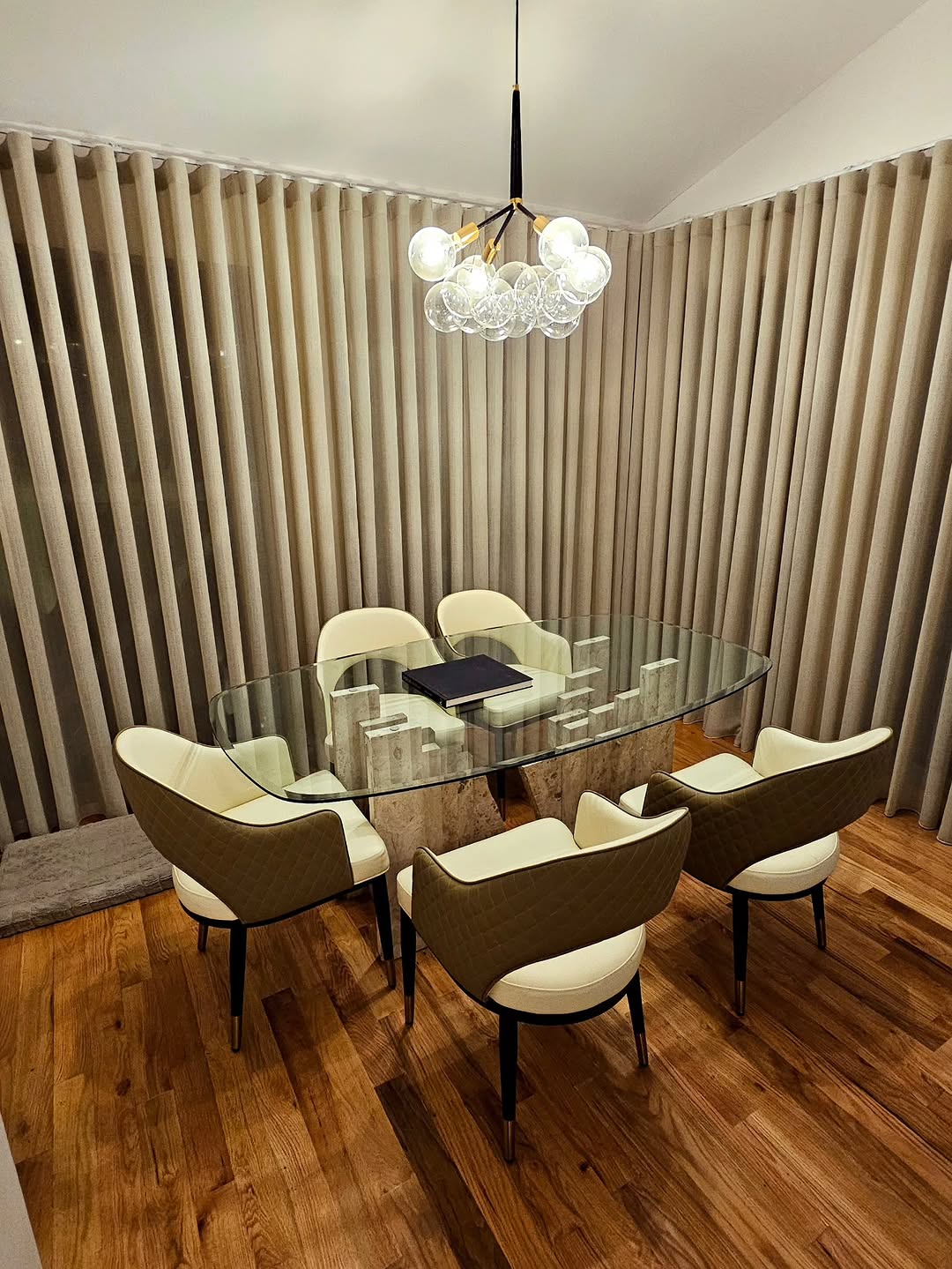 Floor-to-ceiling beige drapery wrapping a dining room