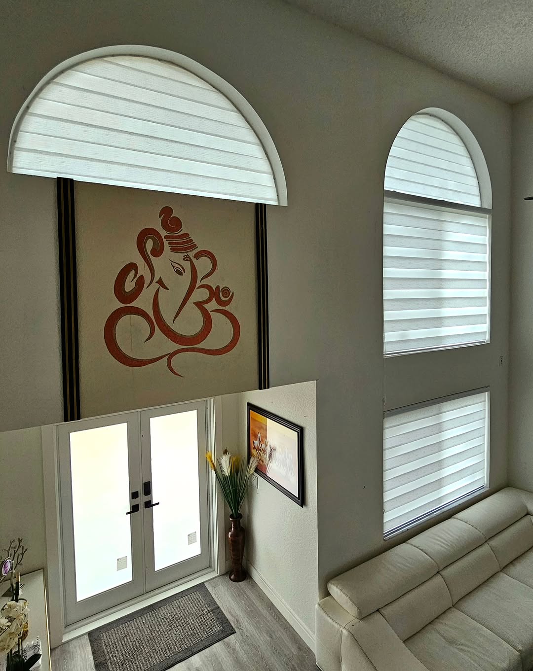 Zebra blinds on stacked and arched windows in a two-story entry